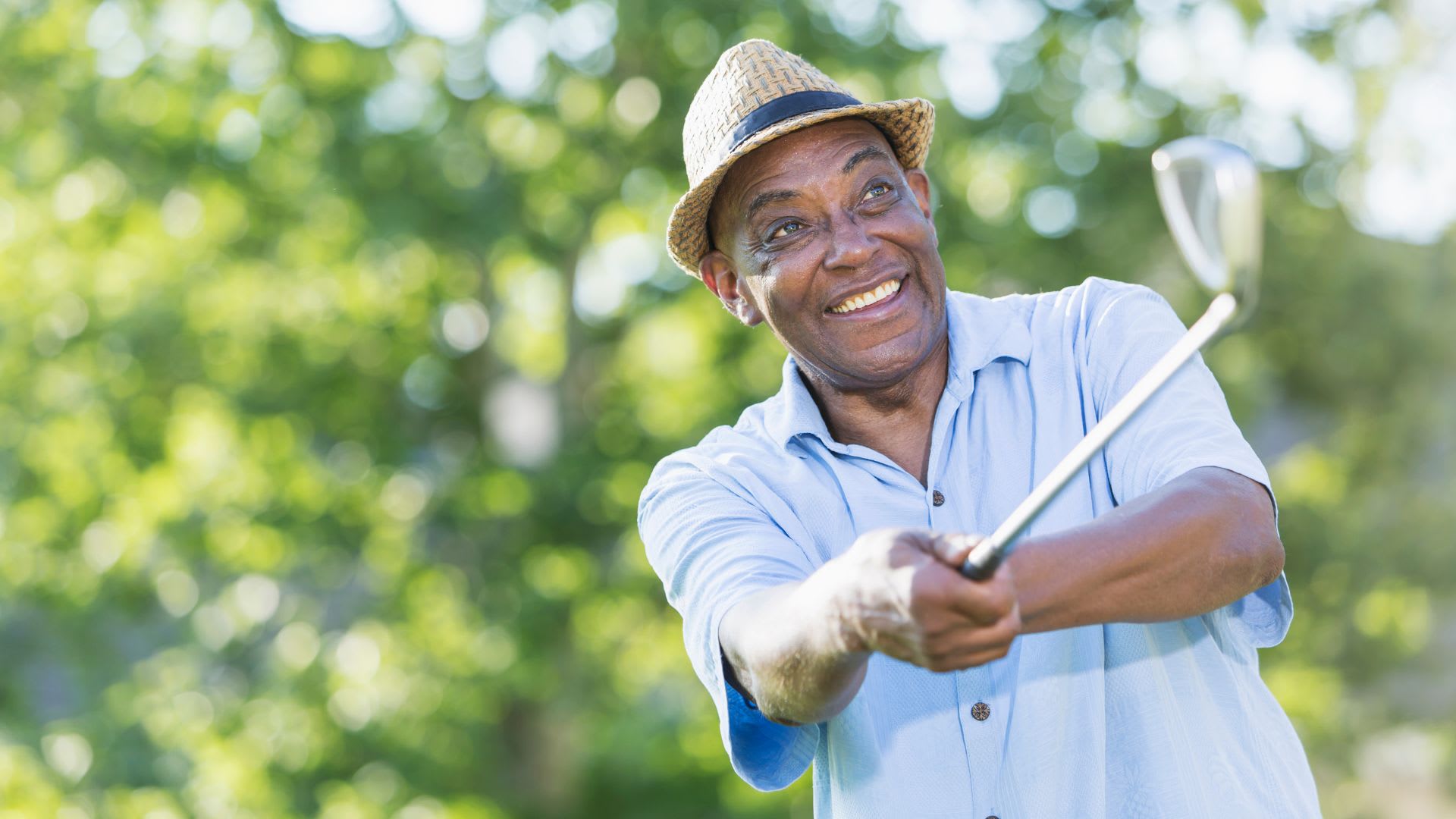 man happy to have made a swing playing golf